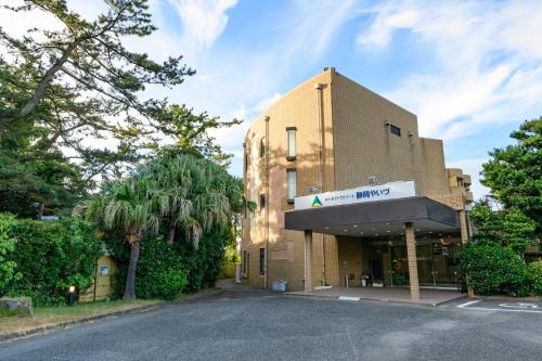a building with a sign on the front of it at Hotel Tetora Resort Shizuoka Yaizu in Yaizu