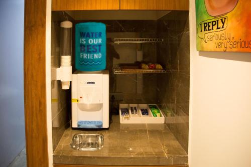 a water is our best friend in a cup refrigerator at 7 Apple Hotel - Viman Nagar Pune in Pune