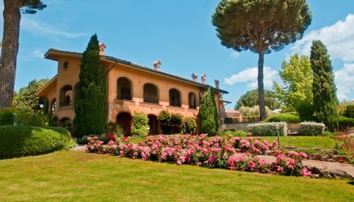a house with a garden with pink flowers at Tenuta Cusmano in Grottaferrata