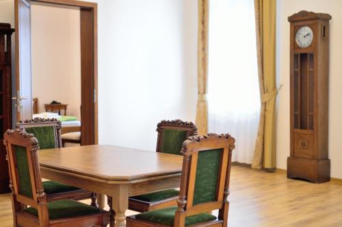 a dining room with a table and chairs and a clock at WenderEDU Business Center in Wrocław