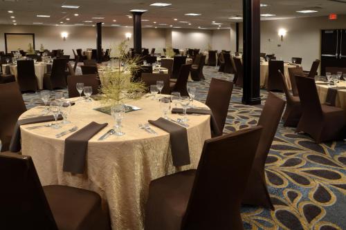 a conference room with tables and chairs with wine glasses at Holiday Inn Canton-Belden Village by IHG in Canton