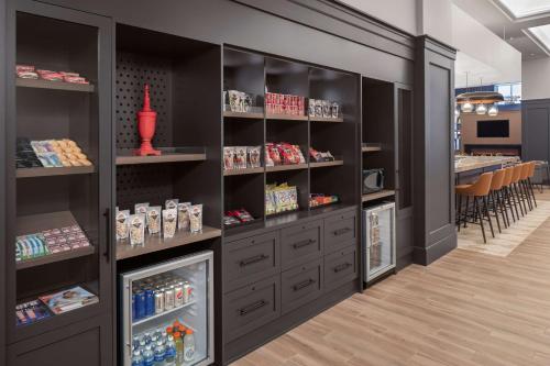 a store with black shelves and a dining room at Hyatt Centric Downtown Minneapolis in Minneapolis
