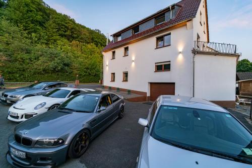 a group of cars parked in front of a building at North Loop Rooms in Adenau