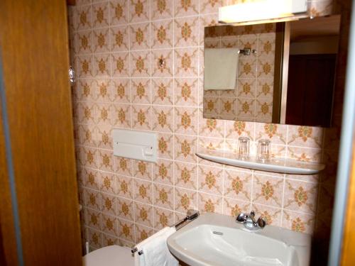 a bathroom with a sink and a mirror at Bio & Vegi Pension Krennleiten in Schönau am Königssee
