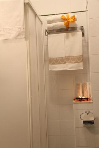 a bathroom with a shower with towels and a bow at Hotel I Platani in Siena