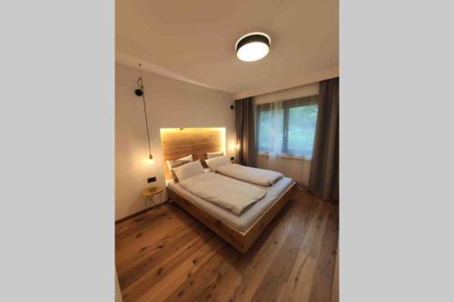a bedroom with a bed and a large window at Appartement Toni in Sand in Taufers