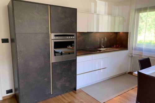 a kitchen with white cabinets and an oven at Appartement Toni in Sand in Taufers