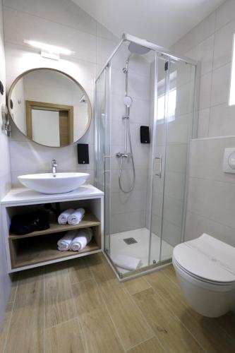 a bathroom with a shower and a sink and a toilet at Villa Verica in Baška Voda