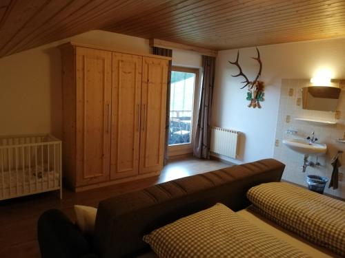 a living room with a couch and a sink at Stockachhof in Fügenberg