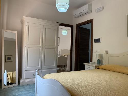 a bedroom with a bed and a mirror at Luna e stelle in Sangineto