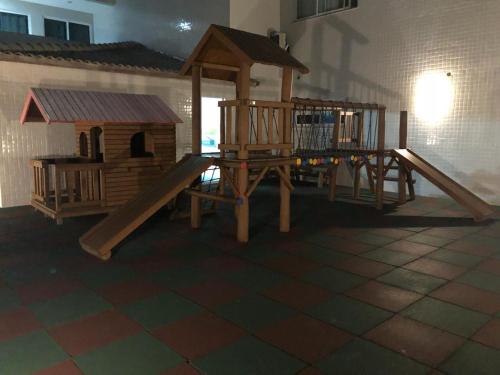 a playground with a slide and a bird house at Praia Grande Arraial do Cabo in Arraial do Cabo