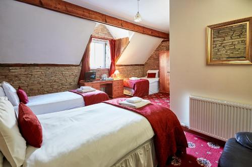 um quarto de hotel com duas camas e uma janela em The Bateman Arms at Shobdon em Shobdon