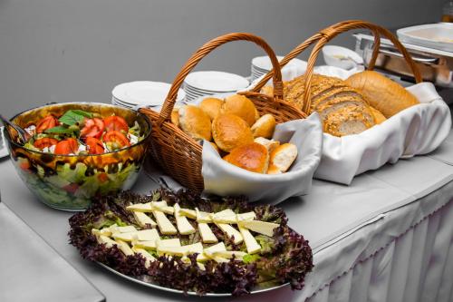 a table with baskets of bread and baskets of food at Savoy in Spała