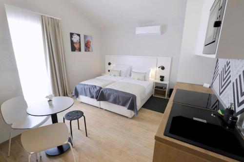 a hotel room with a bed and a table at Villa Verica in Baška Voda