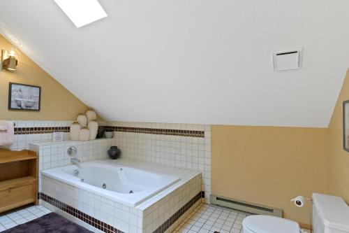 a bathroom with a tub and a toilet at Snowfire 312A in Angel Fire