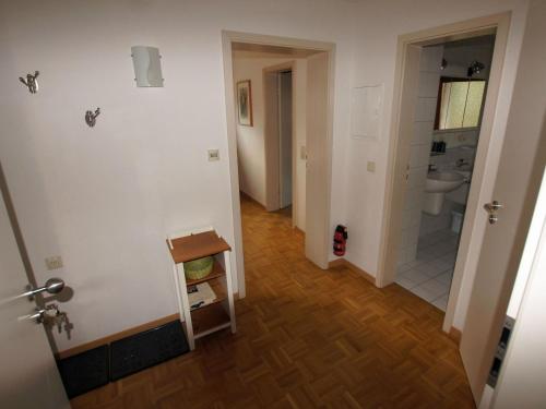 a hallway of a bathroom with a toilet and a sink at Ferienwohnungen Stegen in Stegen