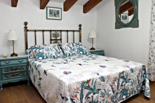 a bedroom with a bed and two night stands at Casa Rural Rectoría de Raspay in Raspay