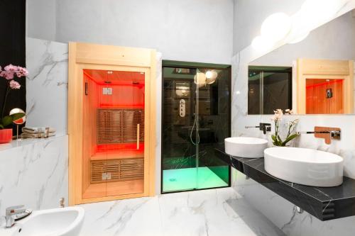 a bathroom with two sinks and a shower at Hotel Cannobio in Cannobio