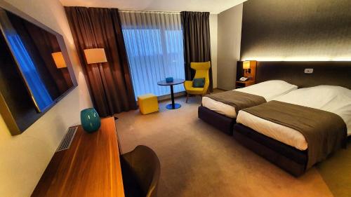 Postel nebo postele na pokoji v ubytování Hotel Drie Eiken