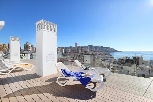 a balcony with chairs and a view of the ocean at Hotel Alameda in Benidorm