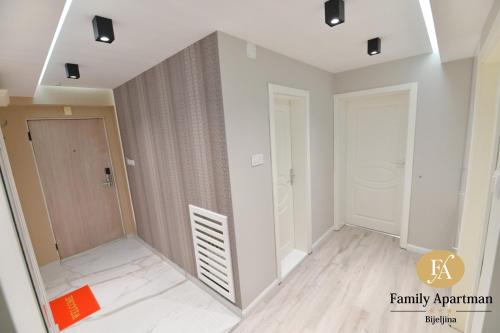 an empty room with a door and a hallway at Family apartman Bijeljina in Bijeljina