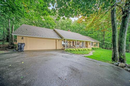 a house with a garage in the middle of a driveway at Birchwood: Bay View in Harbor Springs