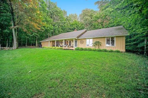 a house with a large lawn in front of it at Birchwood: Bay View in Harbor Springs