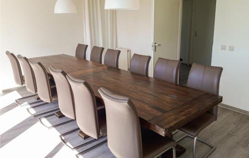 a conference room with a wooden table and chairs at Cozy Home In Vlagtwedde With Lake View in Vlagtwedde