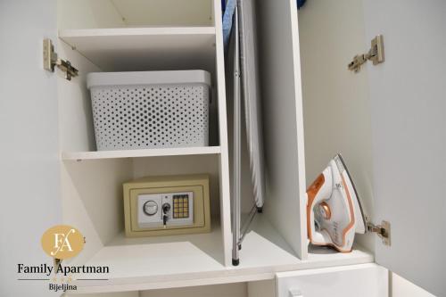 a cabinet with an electrical outlet in a room at Family apartman Bijeljina in Bijeljina