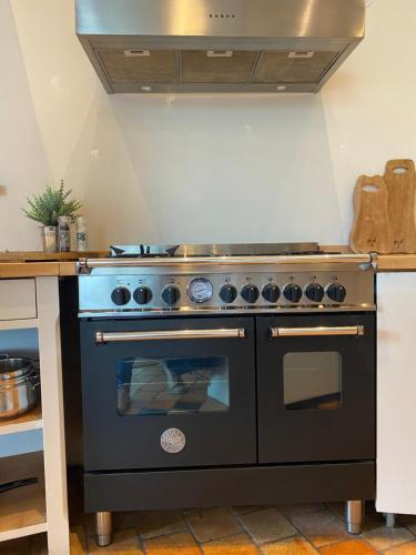 a kitchen with a black oven in a kitchen at Hajé Hotel Restaurant de Lepelaar in Lelystad