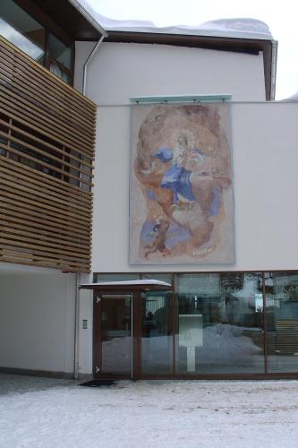 a large painting on the side of a building at Residence Flora in Solda