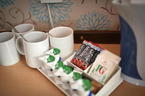 a tray of sushi and cups on a table at The Continental Hotel, Derby in Derby
