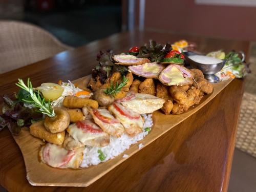 a plate of food on a wooden table at Malom Club Panzió in Baja
