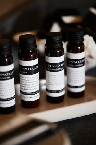 a group of four prescription bottles sitting on a shelf at B&B Sett in Horebeke
