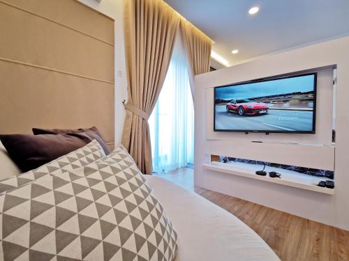 a living room with a red car on the tv at Simfoni Balakong Internet & Netflix Designer Studio in Kampong Baharu Balakong