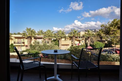 two chairs and a table on a balcony with a view at Del Mar 'Adults Only' in Stalida