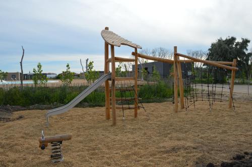 a playground with a slide in the sand at Camping Les Bois Flottés in Salin-de-Giraud