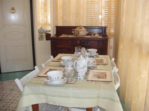 a table with a tea set on top of it at Bed and Breakfast Angolo Fiorito in Civitavecchia