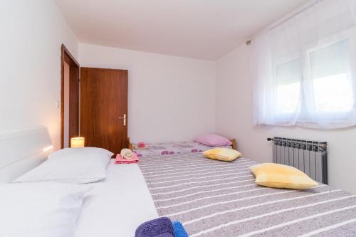 Postel nebo postele na pokoji v ubytování Apartments Kenđel