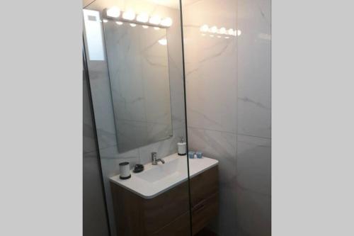 a bathroom with a sink and a mirror at IRIS by Amanakis Family in Hersonissos
