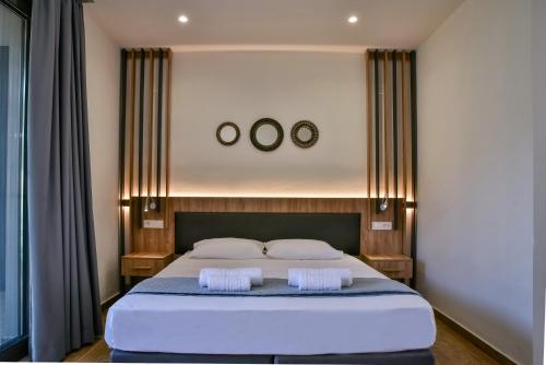 a bedroom with a large bed with two mirrors on the wall at Del Mar 'Adults Only' in Stalida