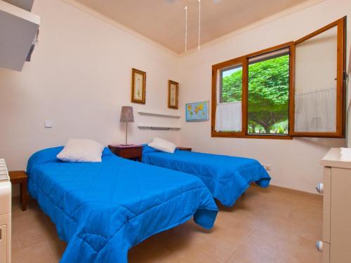 A bed or beds in a room at Villa Can Coll de Sencelles, Sa Vileta pool and views