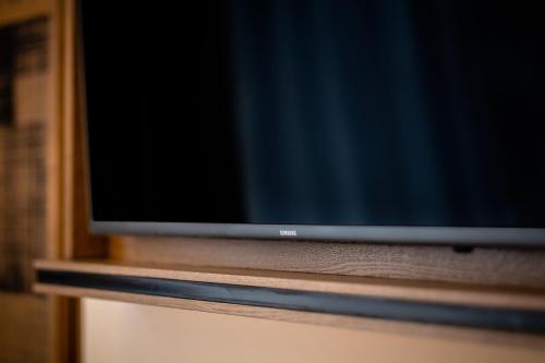 a flat screen tv sitting on a wooden shelf at Hotel Indigo Manchester - Victoria Station by IHG in Manchester
