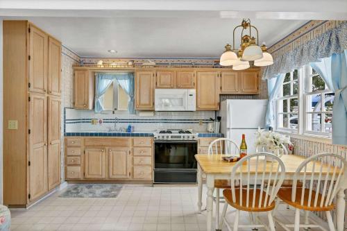 a kitchen with wooden cabinets and a table with chairs at 201 Amethyst Avenue in Newport Beach