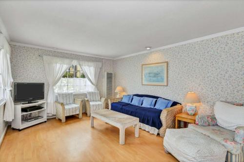 a bedroom with a blue bed and a tv at 201 Amethyst Avenue in Newport Beach