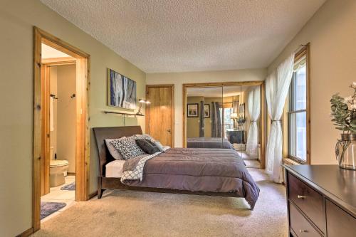 a bedroom with a bed and a bathroom at Cozy Condo on Vasquez Creek with Free Shuttle Access in Winter Park