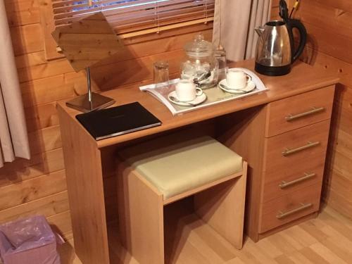 a small wooden desk with a chair and a table at The Theberton Lion in Theberton