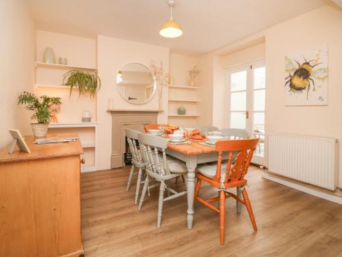 a kitchen and dining room with a table and chairs at 3 Lowerbourne Terrace in Minehead