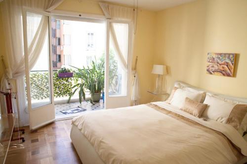 a bedroom with a large bed and a large window at Chill Out Apartment, 2 mins from beach in Nice