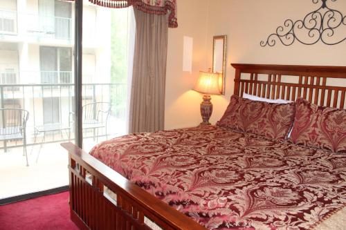 a bedroom with a large bed and a balcony at Oak Square 201 in Gatlinburg